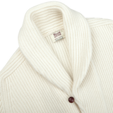 Close-up of an Ecru Beige Lambswool Shawl Collar Cardigan by William Lockie, featuring a ribbed-knit texture, a shawl collar, and a single dark button. The label inside reads "William Lockie.