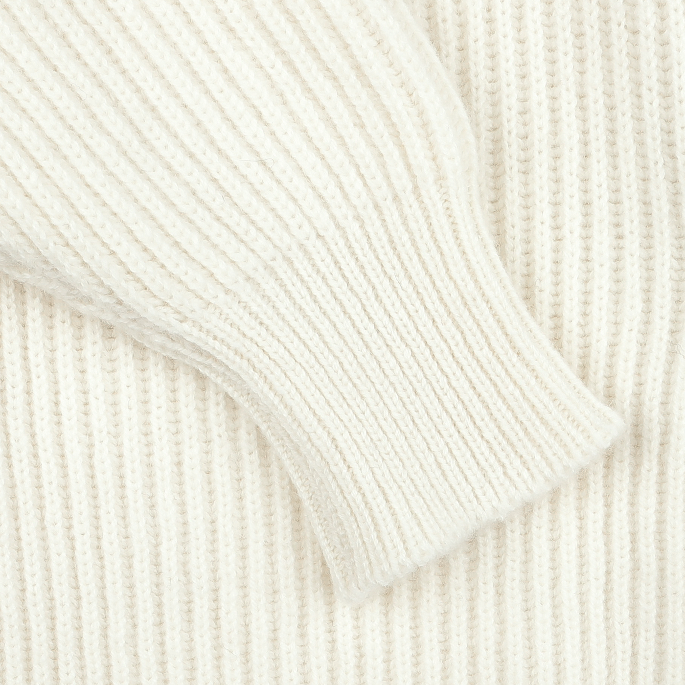 Close-up of a sleeve from the William Lockie Ecru Beige Lambswool Shawl Collar Cardigan, resting on a matching ribbed knit fabric background.