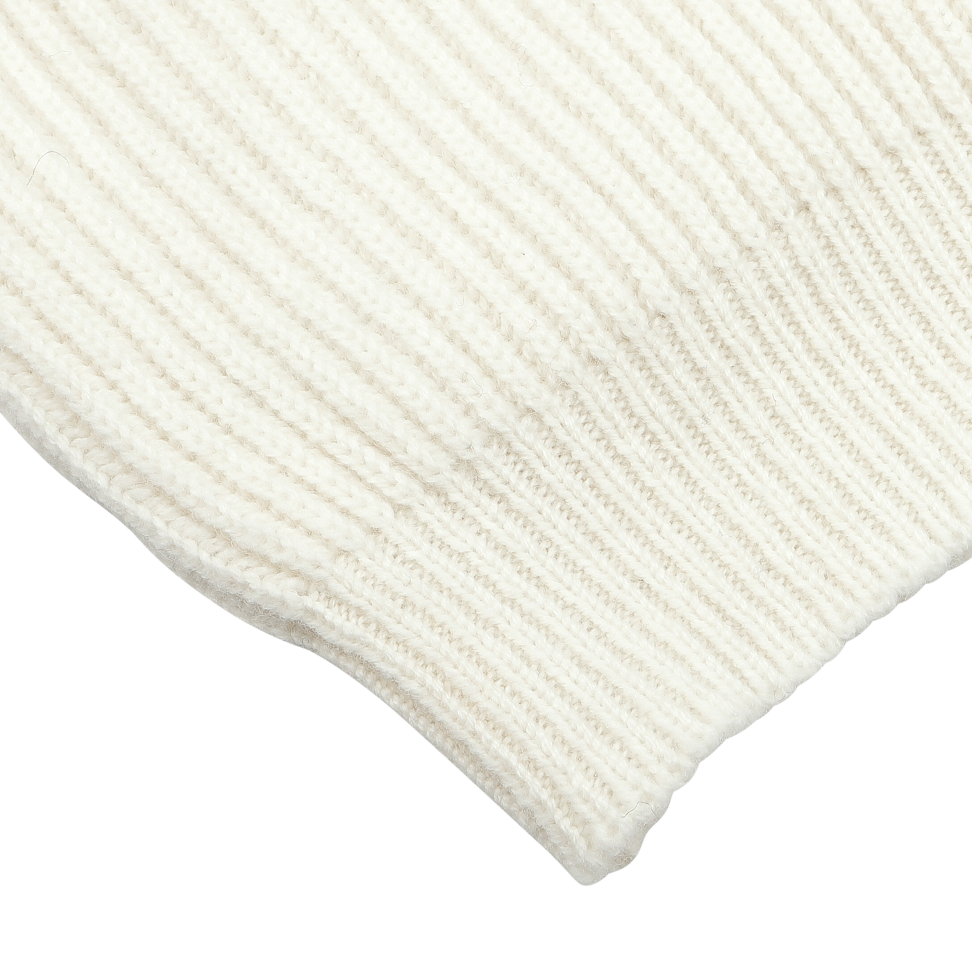 Close-up of the ribbed cuff of a white knitted fabric, revealing its texture and detail—a cozy touch to the William Lockie Ecru Beige Lambswool Shawl Collar Cardigan.