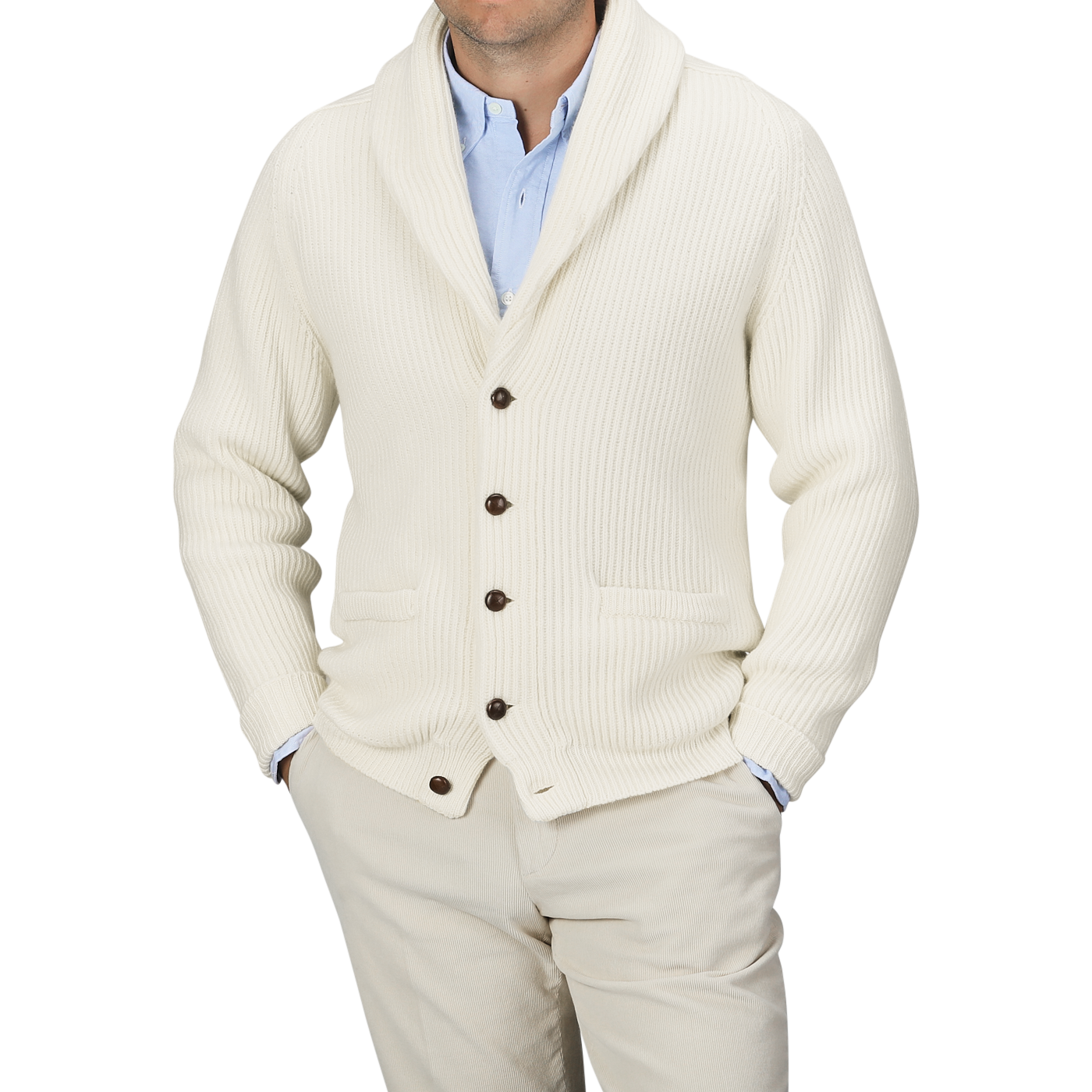 A person wearing a light blue shirt, beige pants, and an Ecru Beige Lambswool Shawl Collar Cardigan by William Lockie with leather buttons. The person's face is not visible.