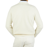 The back view of a man wearing a William Lockie Ecru White Lambswool V-Neck Sweater, creating a smart casual look.