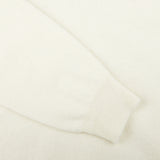 A close up of a William Lockie Ecru White Lambswool V-Neck Sweater.