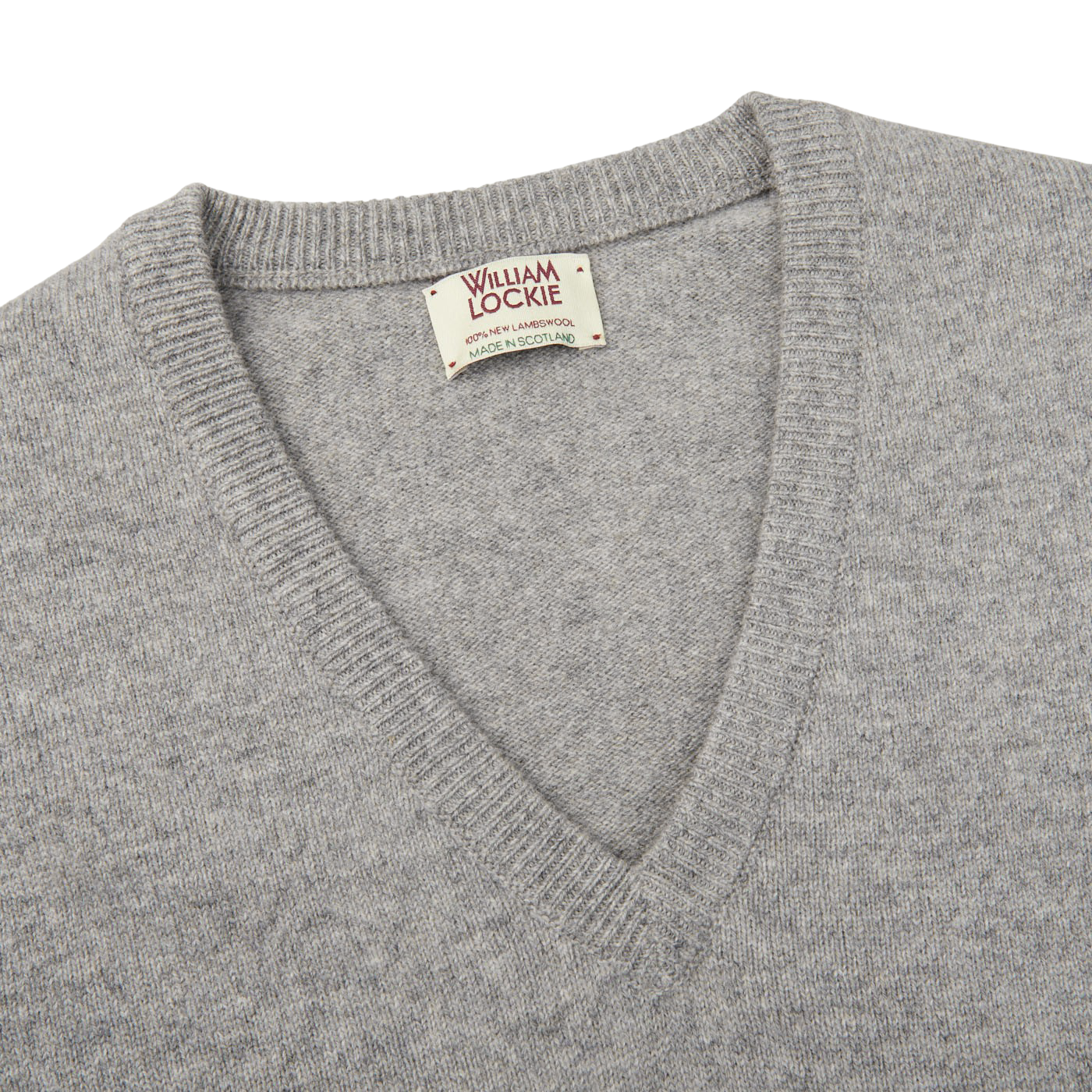 A plush Flannel Grey V-Neck Lambswool Sweater, crafted from luxurious Scottish lambswool, with a small William Lockie label accent.