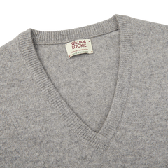 A plush Flannel Grey V-Neck Lambswool Sweater, crafted from luxurious Scottish lambswool, with a small William Lockie label accent.