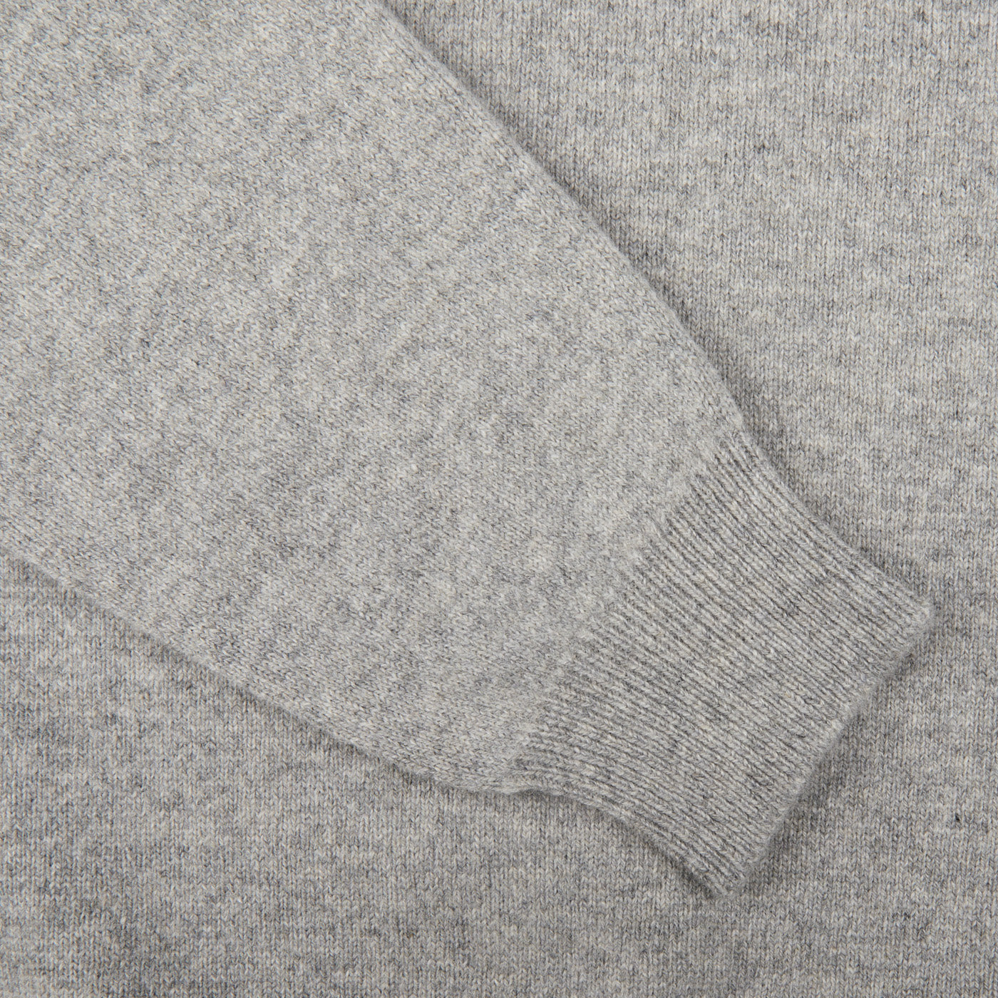 An exquisite Scottish lambswool knitwear, showcasing a William Lockie Flannel Grey V-Neck Lambswool Sweater in close-up.