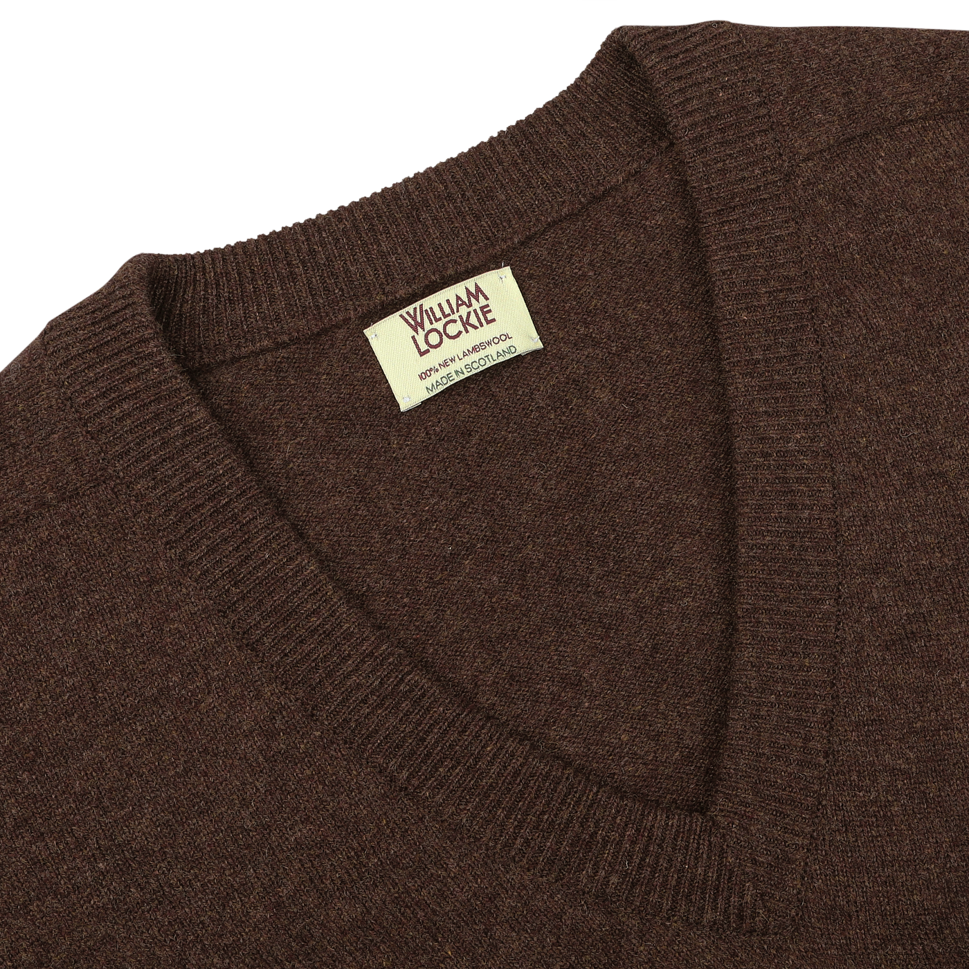 A close-up of the Hickory Brown Deep V-Neck Lambswool Sweater with a label inside the collar that reads "William Lockie, Made in Scotland.