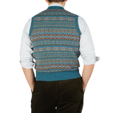 The back view of a man wearing a William Lockie Hunter Blue Fair Isle V-Neck Lambswool Slipover made of Scottish lambswool.