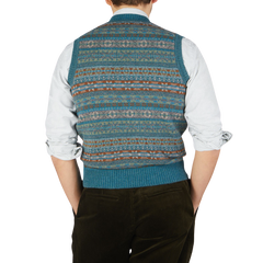 The back view of a man wearing a William Lockie Hunter Blue Fair Isle V-Neck Lambswool Slipover made of Scottish lambswool.