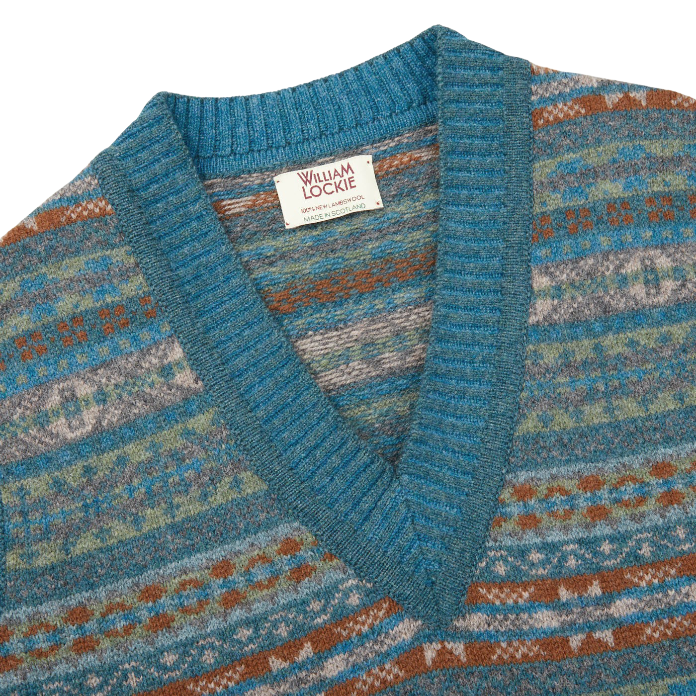 The William Lockie Hunter Blue Fair Isle V-Neck Lambswool Slipover, made of Scottish lambswool, features a blue and brown Fairisle pattern.