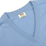 Close-up of an Iceberg Blue Deep V-Neck Lambswool Sweater with a visible label that reads "William Lockie.