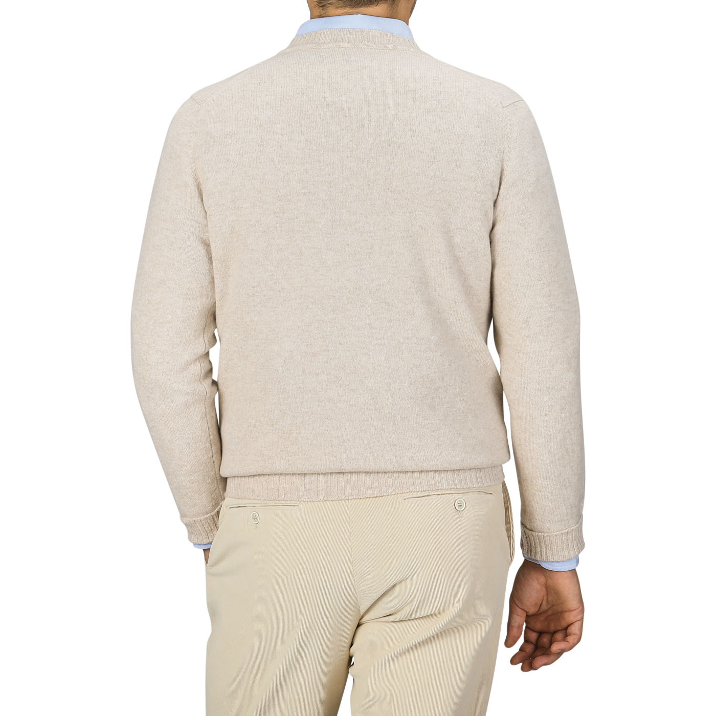 A person wearing a William Lockie Linen Beige Crew Neck Lambswool Sweater and khaki pants, viewed from the back, standing against a plain, neutral background. The outfit exudes timeless elegance, reminiscent of William Lockie's fine Scottish lambswool craftsmanship.