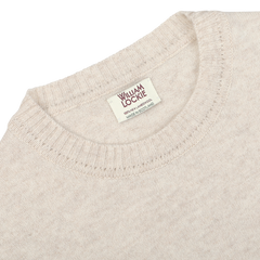 A close-up of the Linen Beige Crew Neck Lambswool Sweater by William Lockie, showcasing its luxurious Scottish lambswool craftsmanship.