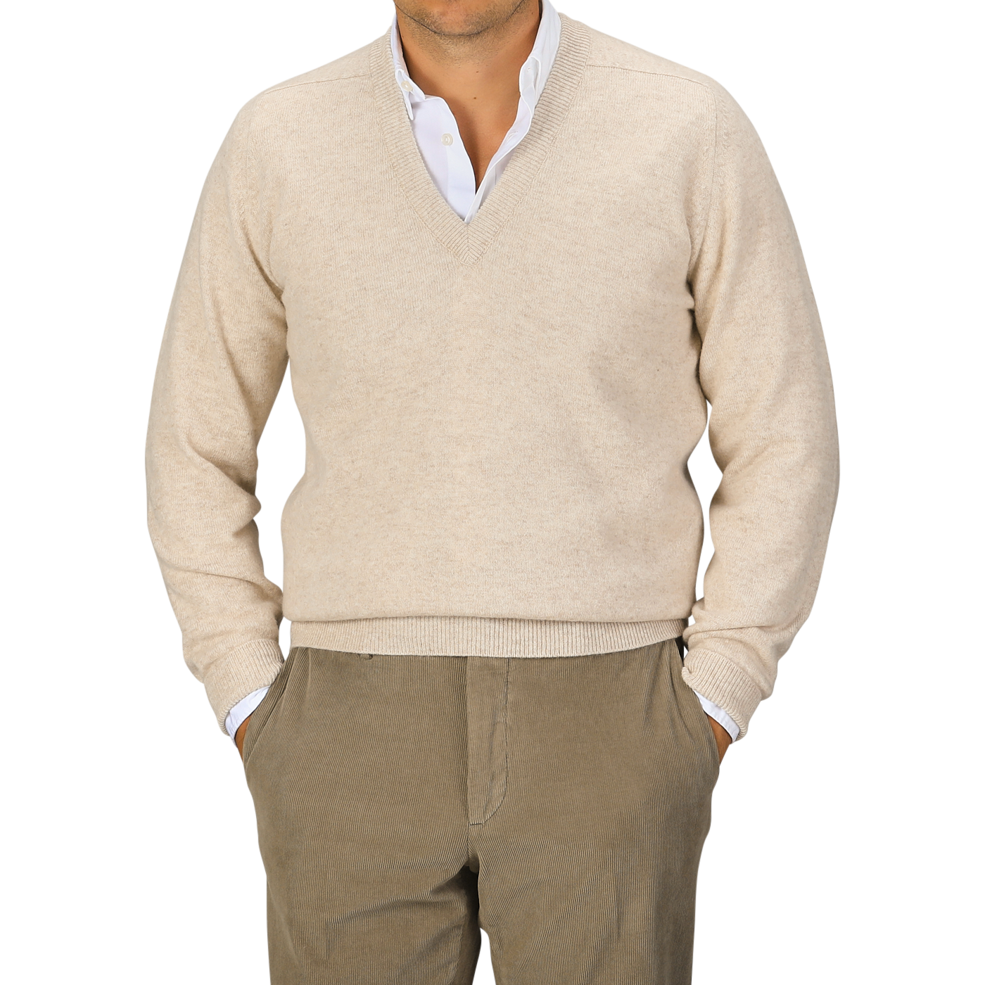 A person is wearing a William Lockie Linen Beige Deep V-Neck Lambswool Sweater over a white collared shirt, paired with light brown trousers. The person's head is partially out of the frame.