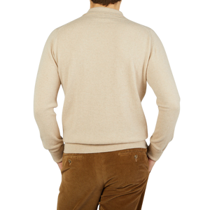 The back of a man wearing a Linen Beige Knitted Cashmere Sportshirt by William Lockie and brown pants.