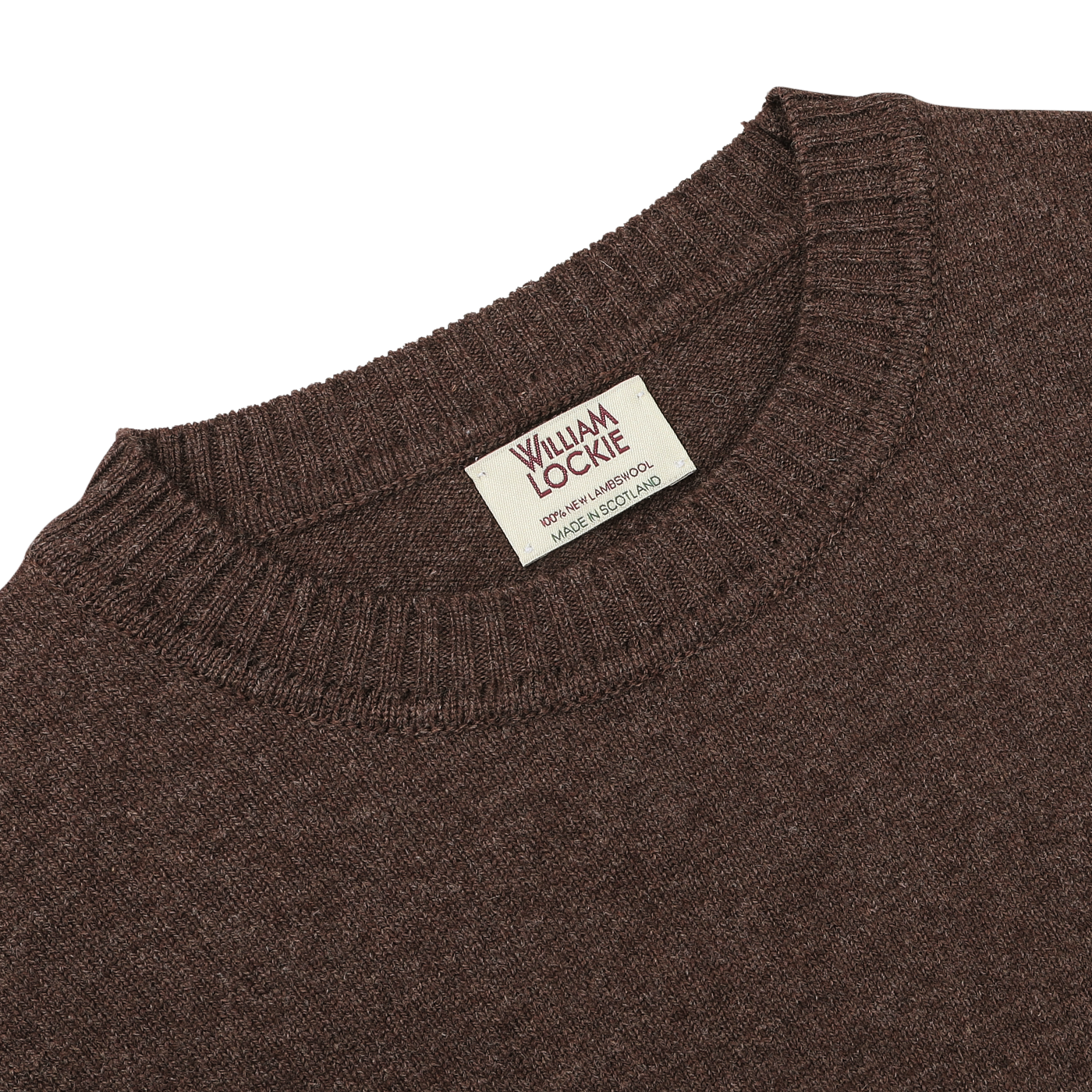 A close-up of the Mocha Brown Crew Neck Lambswool Sweater, crafted by William Lockie, showcasing its luxurious Scottish lambswool and the visible brand tag sewn onto the neckline.