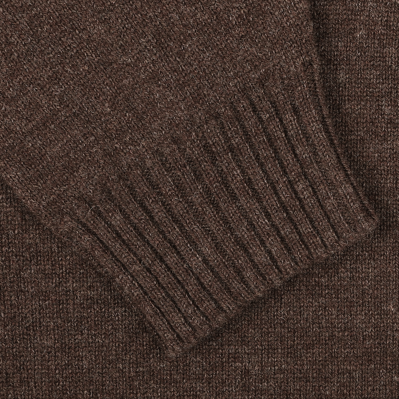 Close-up of a sleeve from the William Lockie Mocha Brown Crew Neck Lambswool Sweater, showcasing the intricate ribbed cuff detail crafted from luxurious Scottish lambswool.