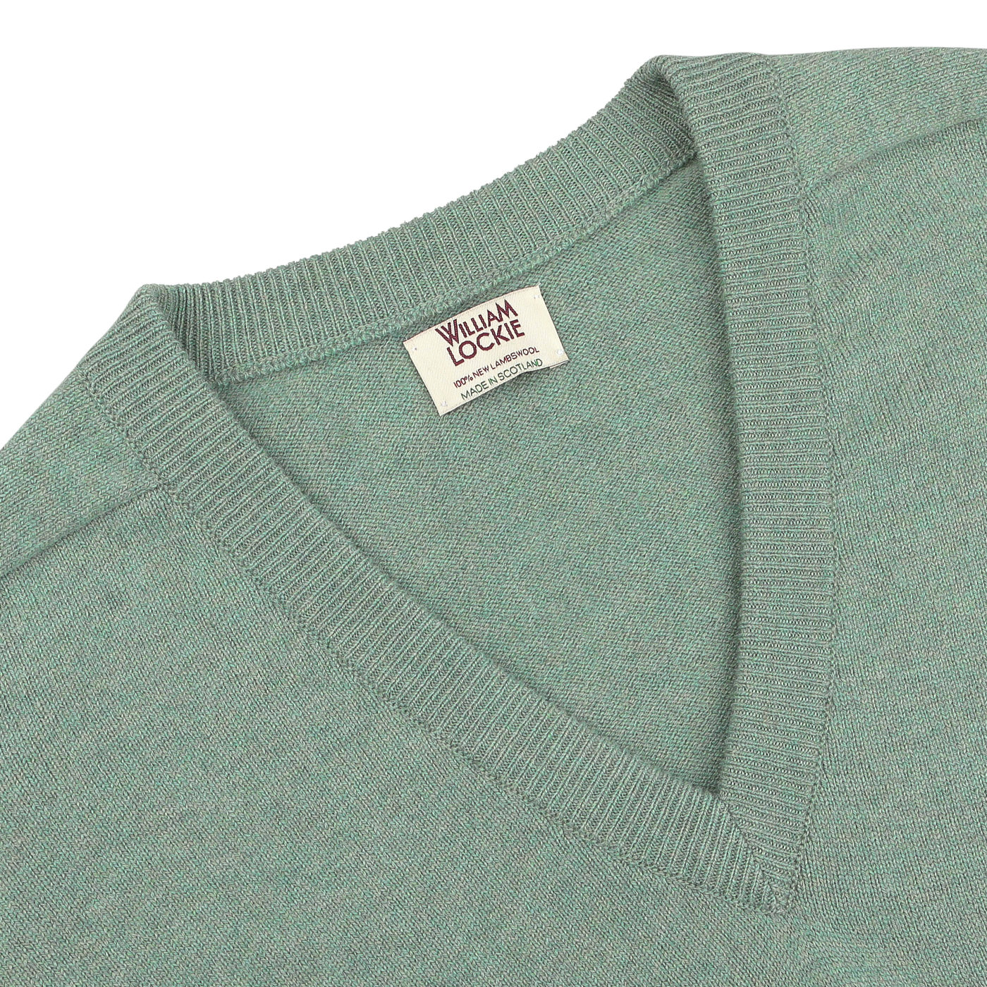 Close-up of a Mojito Green Deep V-Neck Lambswool Sweater with a visible "William Lockie" label near the neckline.