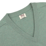 Close-up of a Mojito Green Deep V-Neck Lambswool Sweater with a visible "William Lockie" label near the neckline.