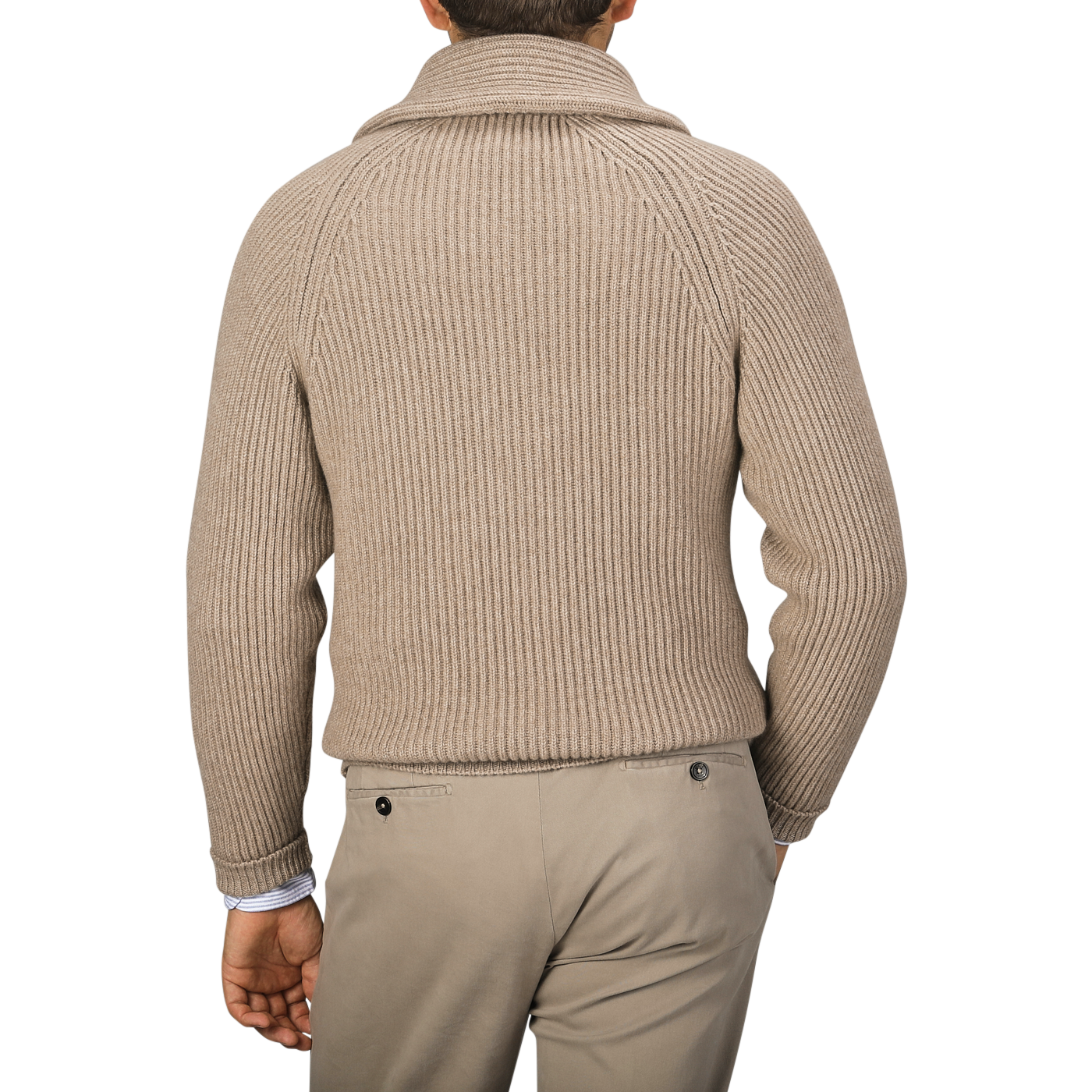 A person is seen from the back wearing a William Lockie Natural Beige Cashmere Shawl Collar Cardigan with leather buttons and light-colored pants.