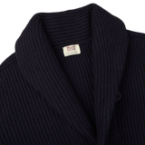 A William Lockie navy blue cashmere shawl collar cardigan with a label on the front.