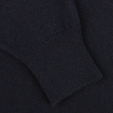 Close-up of a sleeve of the William Lockie Navy Blue Deep V-Neck Lambswool Sweater, showcasing the ribbed cuff detailing.