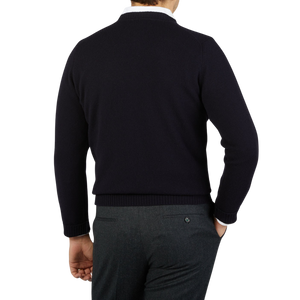 The back view of a man wearing a William Lockie Navy Crewneck Lambswool Sweater.
