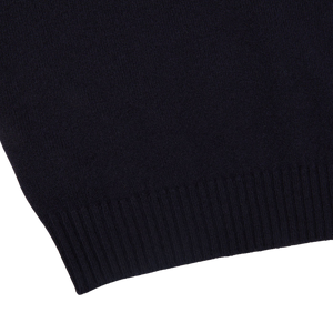A close up of a Navy Crewneck Lambswool Sweater from William Lockie, perfect for layering.