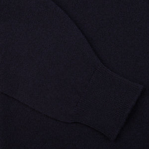 A close up image of a Navy Lambswool Saddle Shoulder Cardigan made by William Lockie.