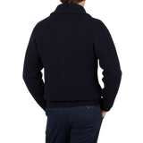 The back view of a man wearing a navy William Lockie Lambswool Shawl Collar Cardigan.
