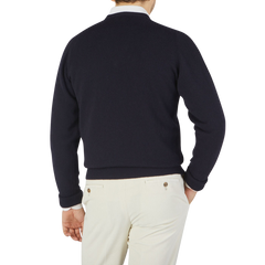 The back view of a man wearing a William Lockie navy Scottish cashmere sweater.