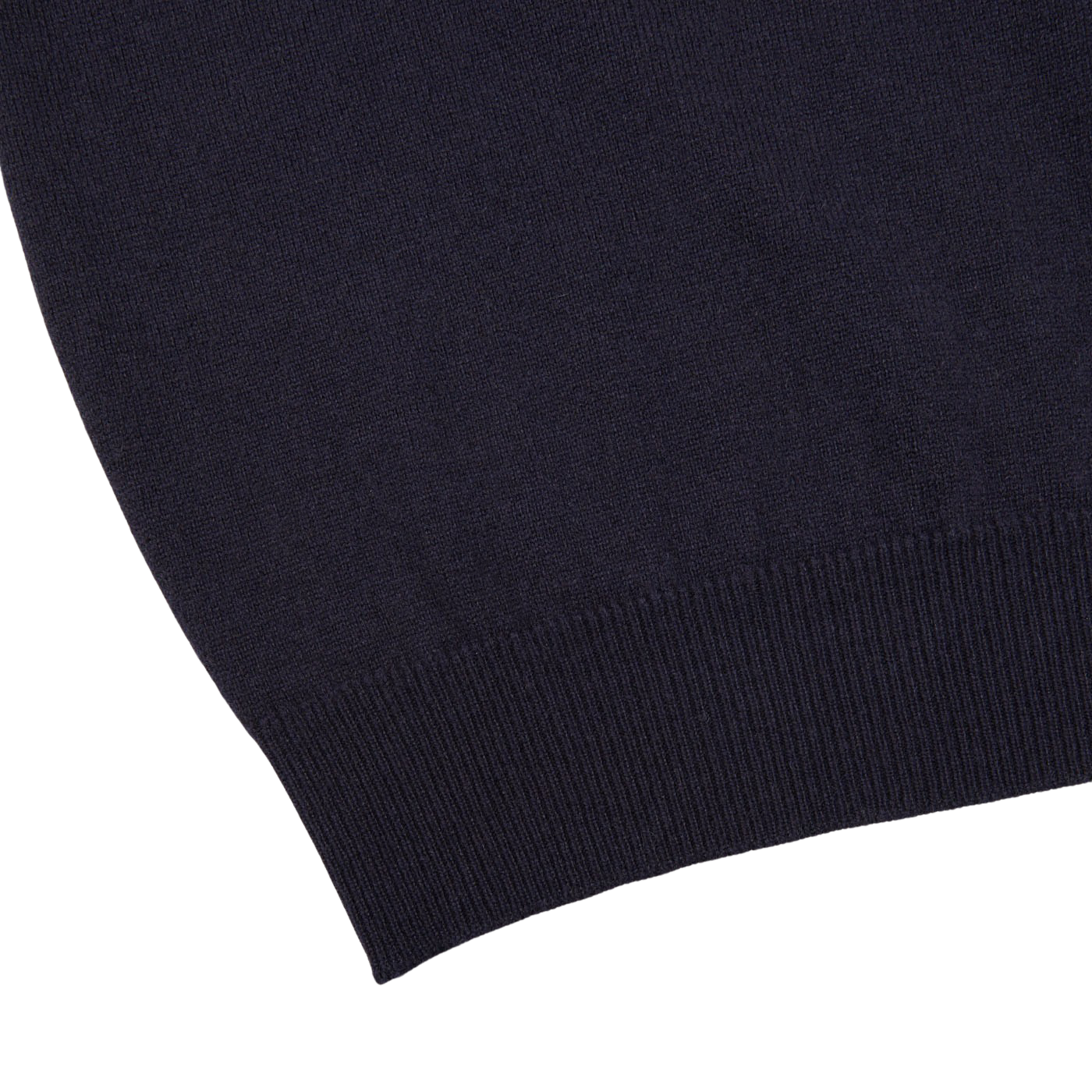 A close up of a William Lockie navy v-neck cashmere sweater with ribbed hems on a white surface.