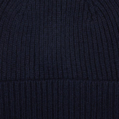 A close up of a William Lockie Nero Navy Cashmere Fine Ribbed Beanie.