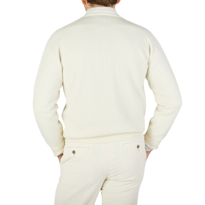 The back view of a man wearing a William Lockie Off-White Deep V-Neck Lambswool Sweater.