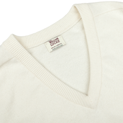 A close-up of an Off-White Deep V-Neck Lambswool Sweater with a visible clothing label reading "William Lockie.