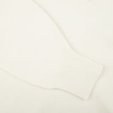 A close up image of a William Lockie Off-White Deep V-Neck Lambswool Sweater.