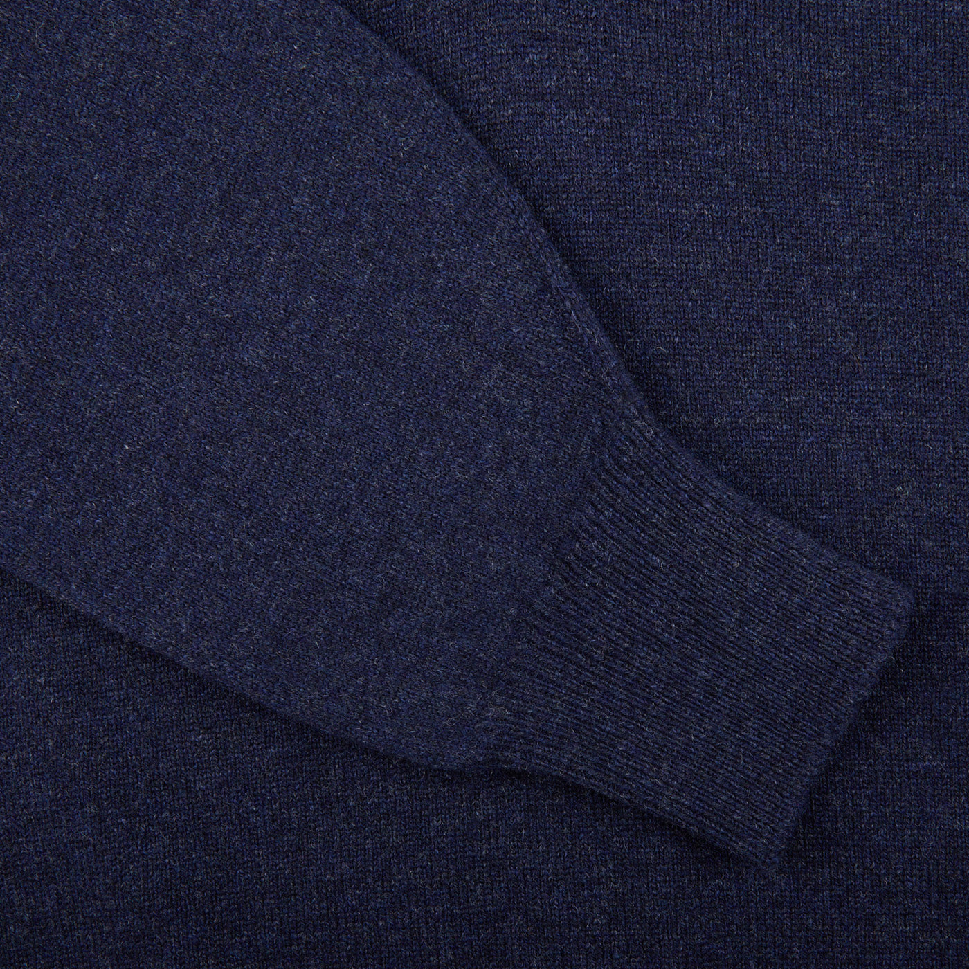 A close up of a William Lockie Oxford Blue Deep V-Neck Lambswool Sweater.