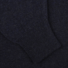 Close-up of the sleeve of a William Lockie Oxford Blue Deep V-Neck Lambswool Sweater, showcasing the ribbed cuff detail and texture.