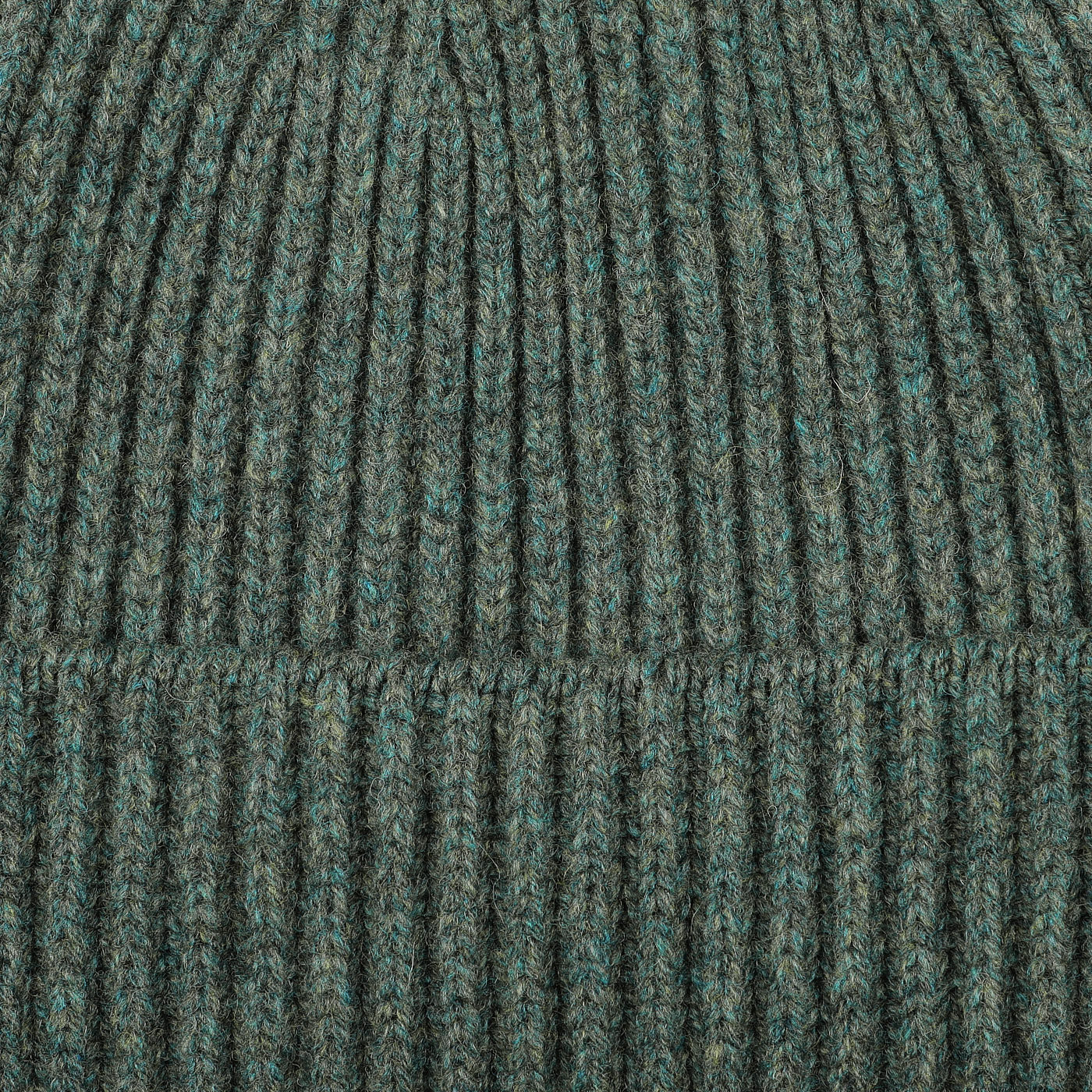 Close-up of the Peacock Geelong Lambswool Ribbed Beanie by William Lockie, highlighting its luxurious ribbed texture.