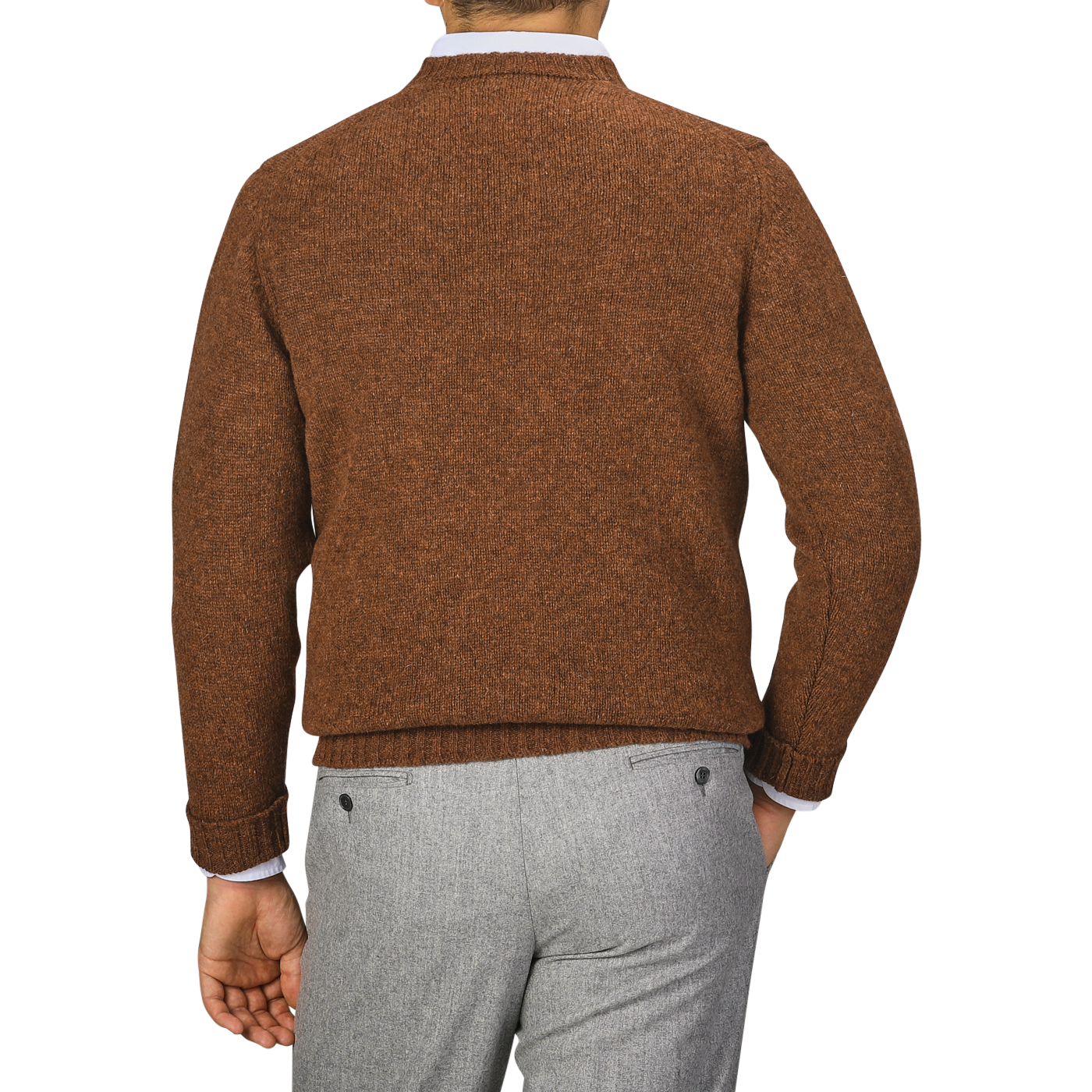 A person wearing a Pecan Brown Shetland Lambswool V-Neck Sweater by William Lockie and gray trousers is shown from the back against a plain background.