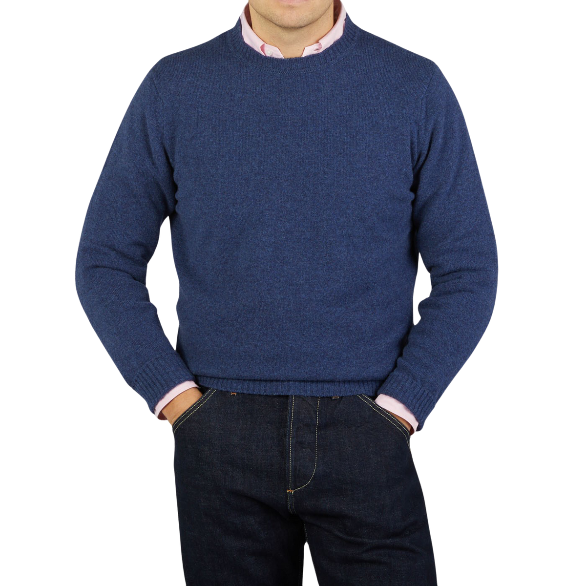 A man wearing a smart casual outfit consisting of a Rhapsody Blue Crew Neck Lambswool Sweater by William Lockie and jeans.
