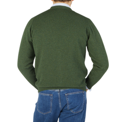 The back view of a man wearing a William Lockie Rosemary Green Lambswool Saddle Shoulder Cardigan.