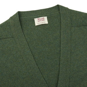 A William Lockie Rosemary Green Lambswool Saddle Shoulder Cardigan with a label on it, perfect for layering.