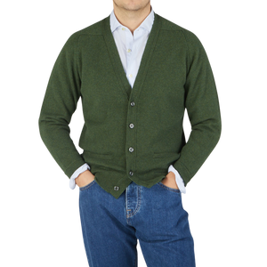 A man wearing a William Lockie Rosemary Green Lambswool Saddle Shoulder Cardigan.