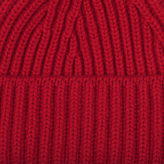 Close-up of the Ruby Red Cashmere Short Ribbed Beanie, highlighting the detailed ribbing texture characteristic of William Lockie's chunky cashmere designs.