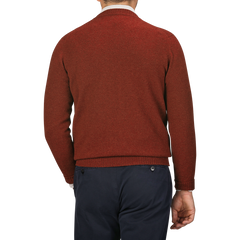 A man in a Sienna Brown William Lockie Crew Neck lambswool sweater and dark blue pants is shown from behind against a gray background.