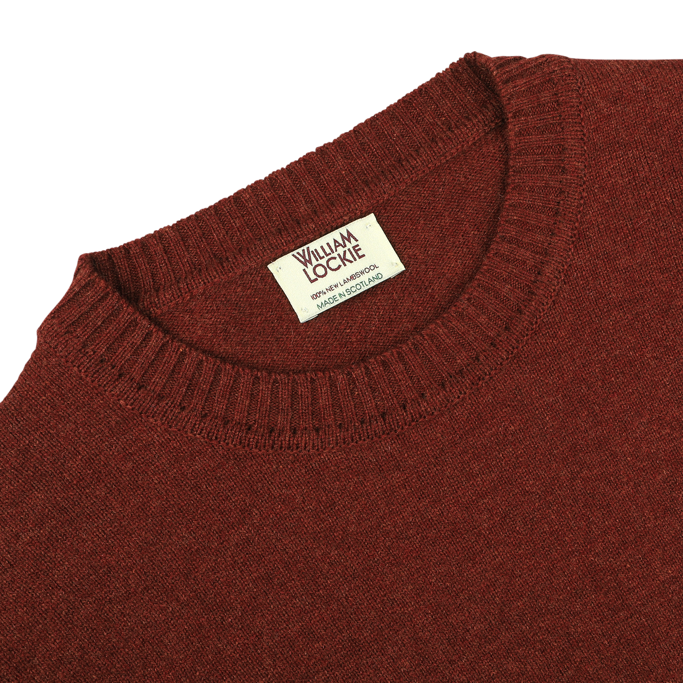 Close-up view of a Sienna Brown Crew Neck Lambswool Sweater with a William Lockie label sewn into the neckline, showcasing premium Scottish lambswool.