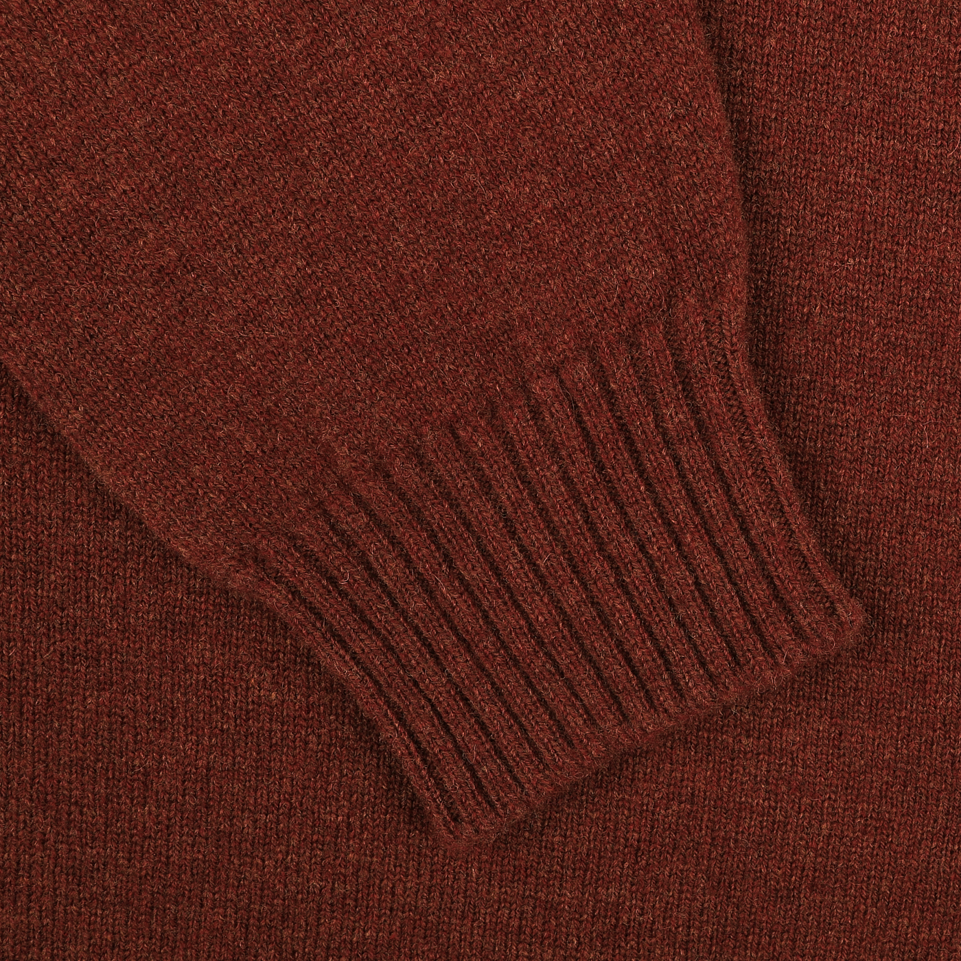 Close-up of a Sienna Brown knitted fabric from a William Lockie lambswool sweater, showcasing a ribbed cuff section.