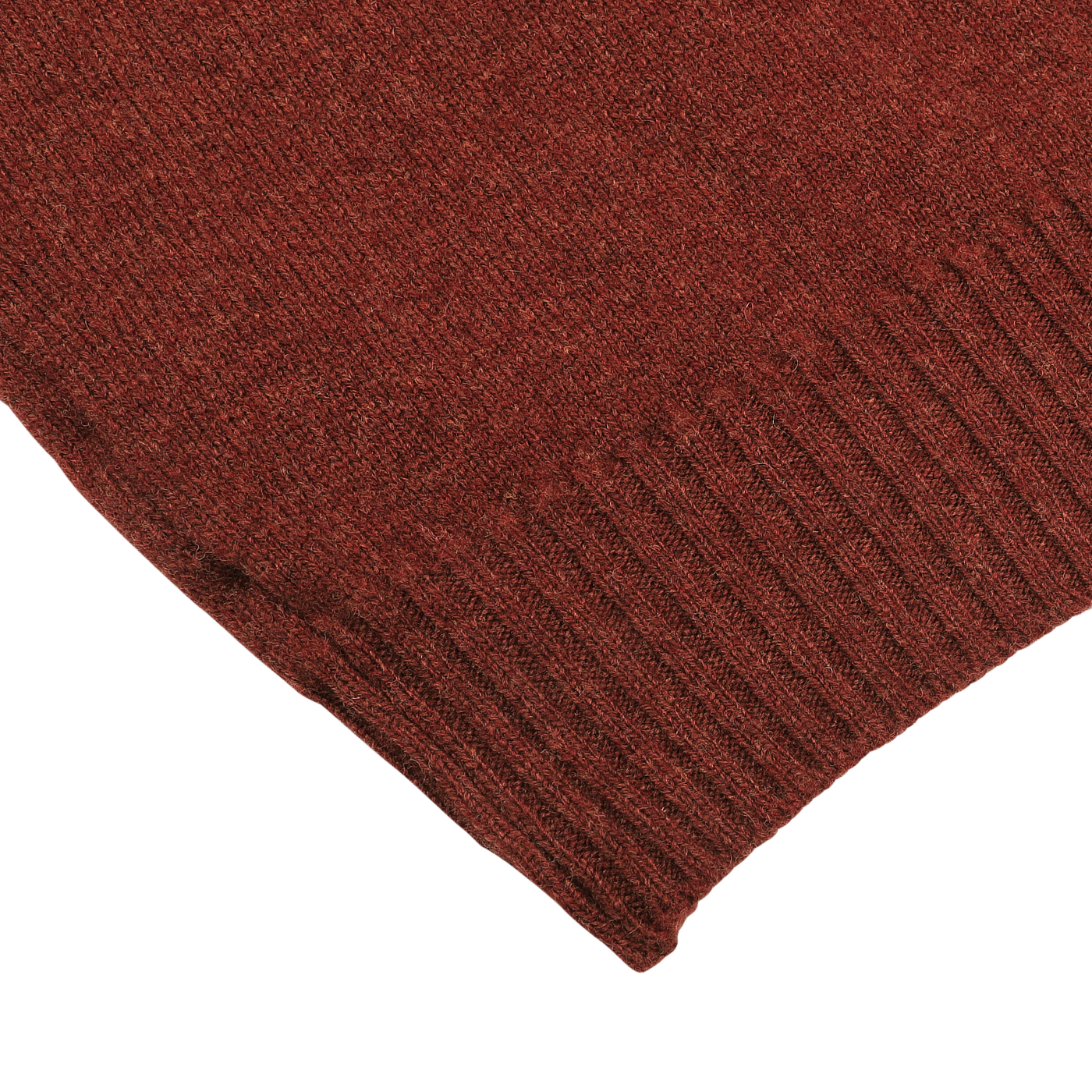 Close-up of a corner of a Sienna Brown knitted fabric with a ribbed pattern on the edge, likely part of a William Lockie lambswool sweater.