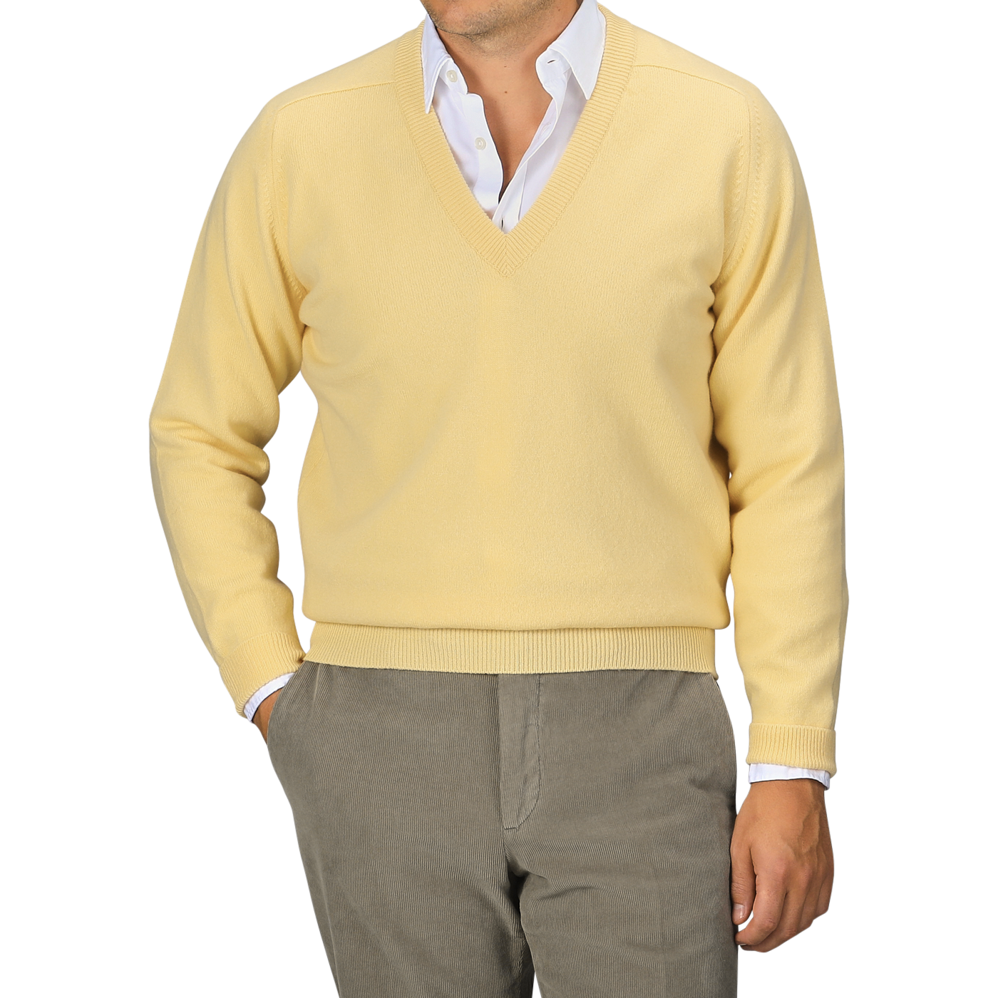 A person wearing a William Lockie Solar Yellow Deep V-Neck Lambswool Sweater over a white collared shirt and gray pants, posed against a neutral background.