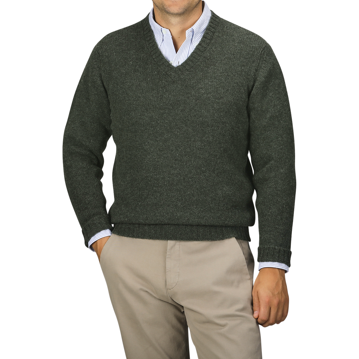 A person is shown from the chest down, wearing a Spruce Green Shetland Lambswool V-Neck Sweater by William Lockie over a light blue collared shirt and beige pants.